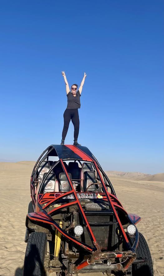 Standing on top of a dune buggy in the Huacachina dunes, Peru