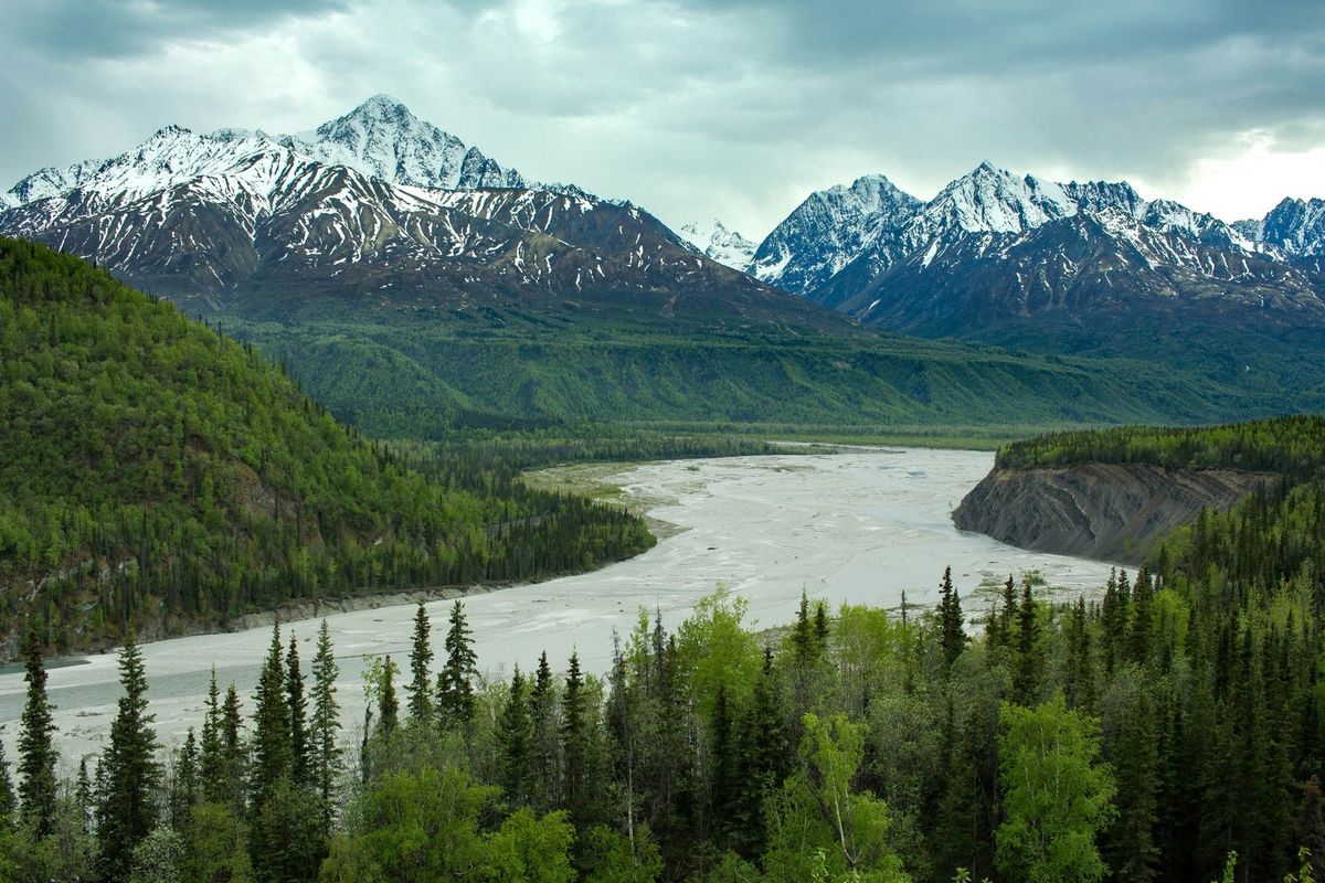 Snow-capped mountains above a braided river valley in Alaska