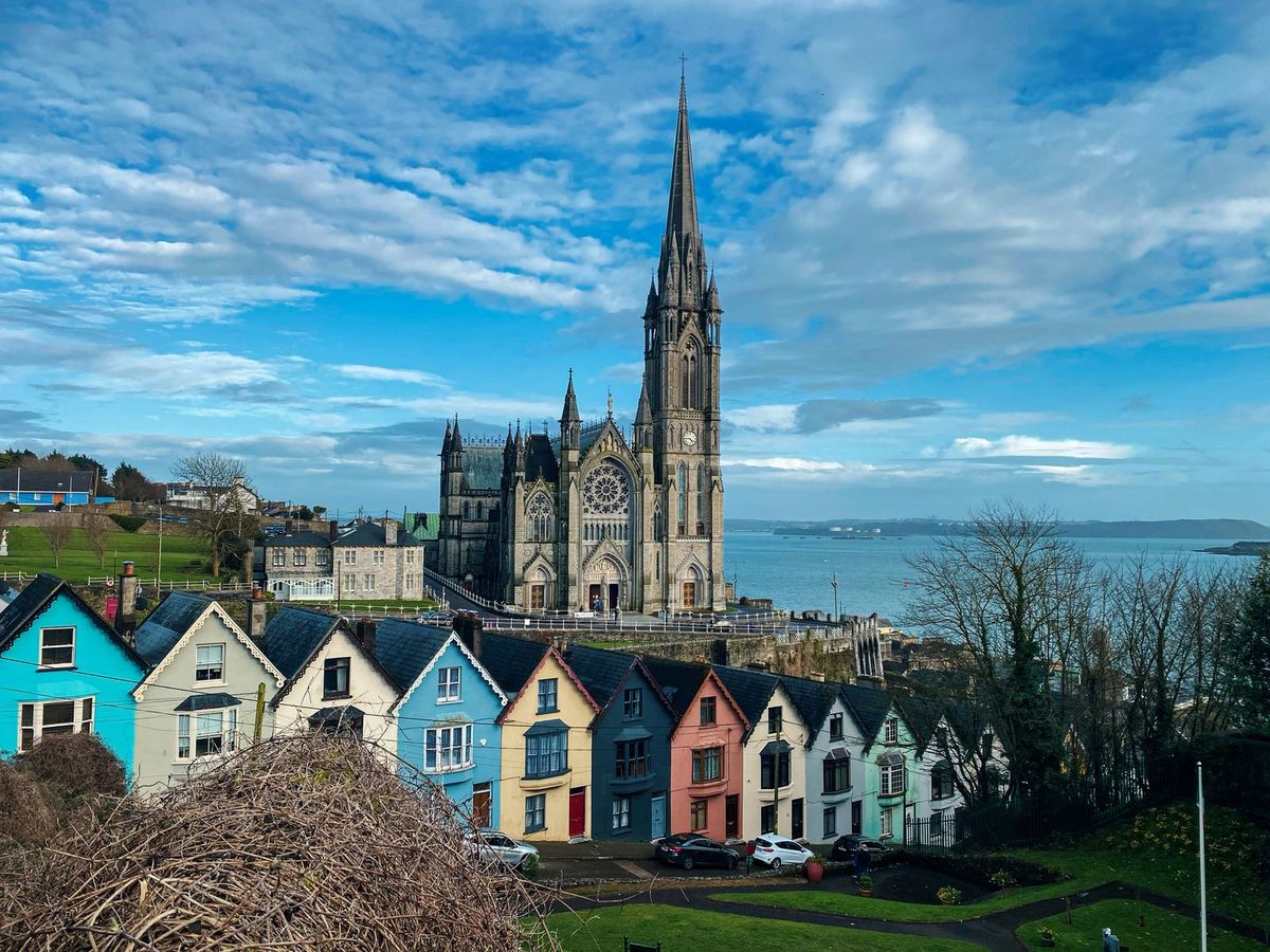 Colorful row houses below St Colman’s Cathedral in Cobh, Ireland